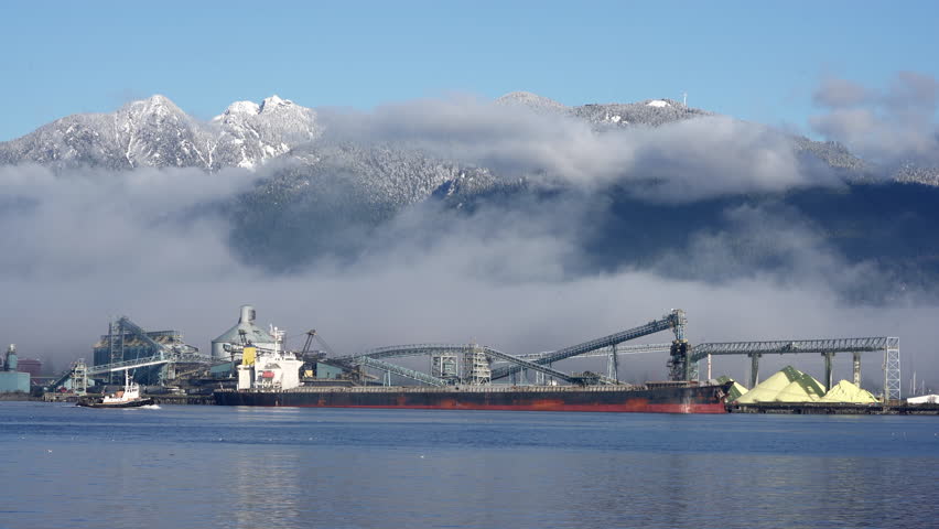 Freighter at North Vancouver Dock 4K UHD.A cargo ship is docked at a marine terminal in North Vancouver.
