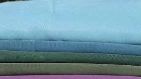 Hijab or head covering fabrics: Chiffon or crepe hijabs in different colors like blue, teal, turquoise, green, olive green, pink, magenta, mauve or purple, and yellow, are displayed in layered folds in an outdoor setting. - Powered by Shutterstock - Get 15% off with code: PIKWIZARD15