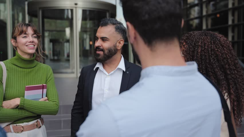Group of business people colleagues having conversation after work and discussing project in a modern urban setting
