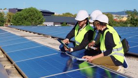 Three diverse electrical engineers discussing maintenance on a rooftop solar farm. The team of technicians is checking the solar cells - Powered by Shutterstock - Get 15% off with code: PIKWIZARD15
