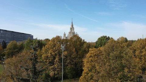 Drone Descending Low Among Trees Park