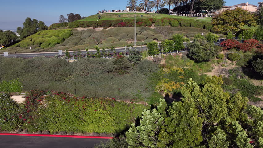 Signal Hill, Long Beach, California, USA - Aerial View of Hilltop Park With e-Bike Riders, People and Airport