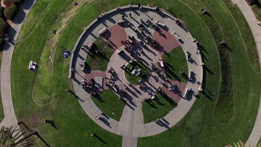 Signal Hill, Long Beach, California, USA - Aerial View of Hilltop Park Looking Down at Biker Riding Electric Bikes and Scooters