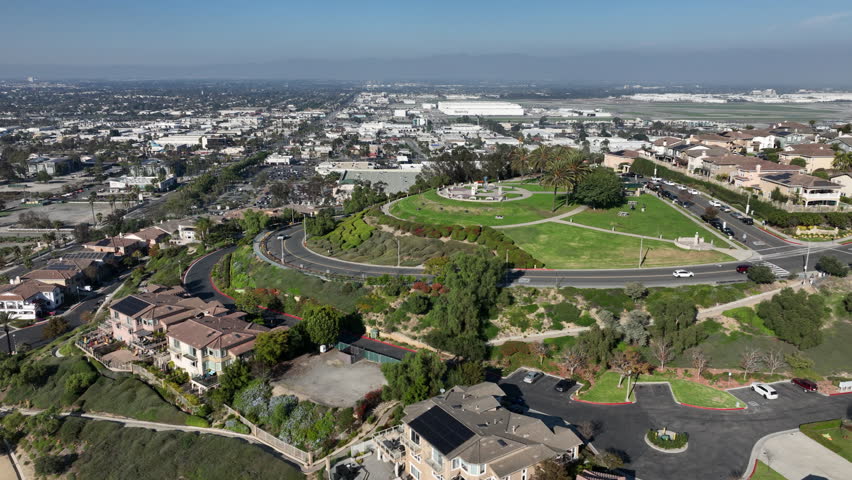 Signal Hill, Long Beach, California, USA - Aerial View of Hilltop Park and Pumping Oil, Homes on Top Overlooking the Airport