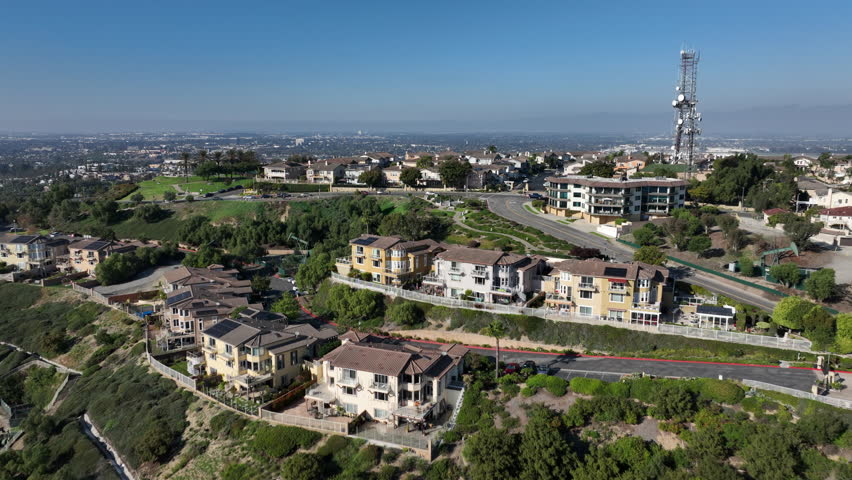 Signal Hill, Long Beach, California, USA - Aerial View of Hilltop Park and Pump Jacks Pumping Oil, Homes on Top, And Shopping Centers
