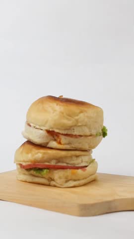 take one of the hamburgers on a cutting board isolated on a white background