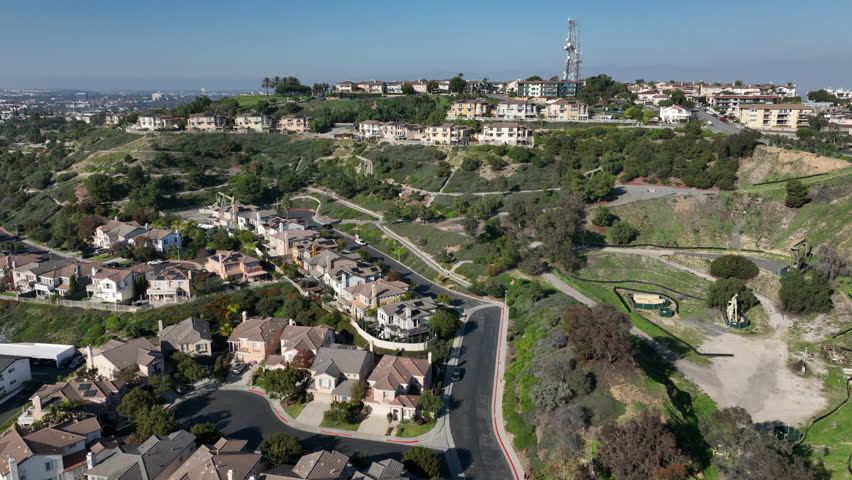 Signal Hill, Long Beach, California, USA - Aerial View of Homes and Hilltop Park With Oil PumpJacks on a Sunny Day