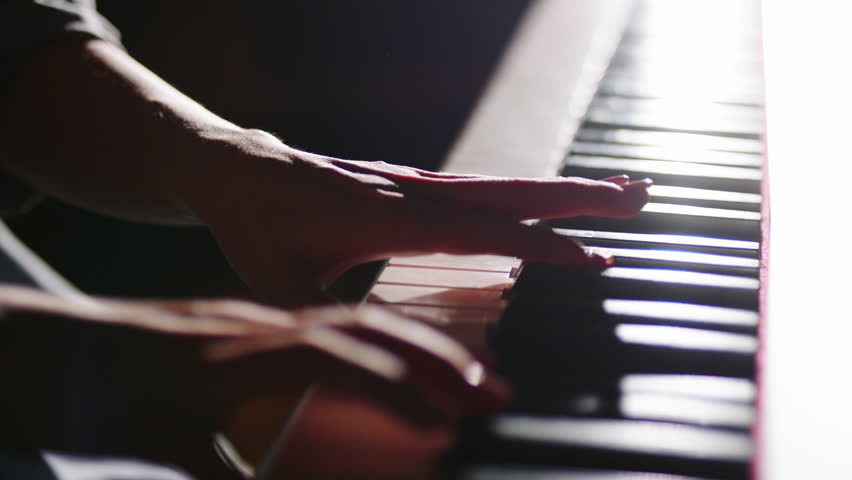 intimate closeup female pianist hands artistic music concept golden bokeh lights