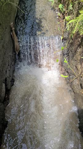 Vertical shot of freshwater drainage cannal or sewer 