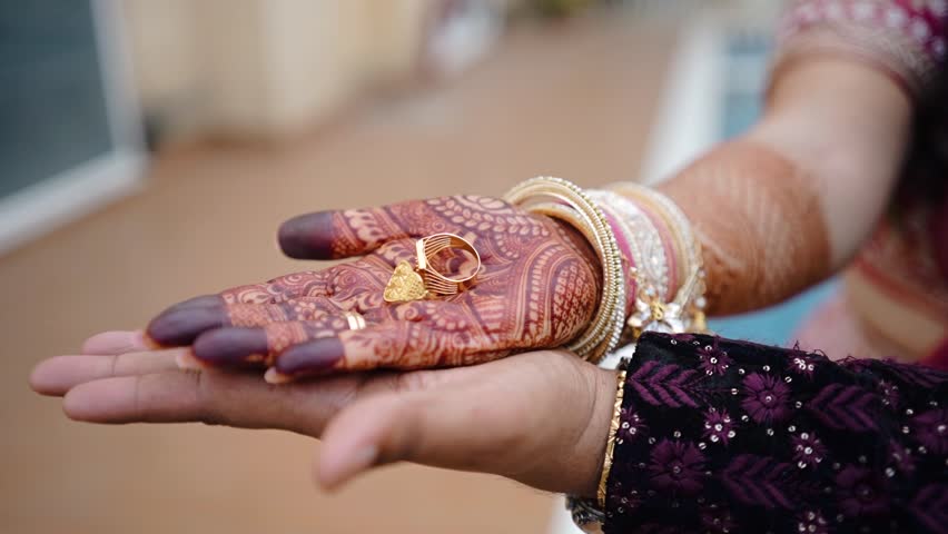 Joyous moment from an Indian ring ceremony where the bride and groom exchange rings as part of their engagement celebration