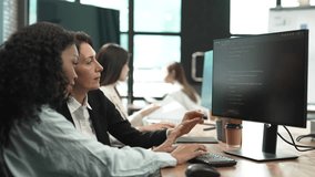 Female developers collaborating while coding on computer screens in a modern office, representing teamwork in tech, software development, programming, and women in technology. - Powered by Shutterstock - Get 15% off with code: PIKWIZARD15