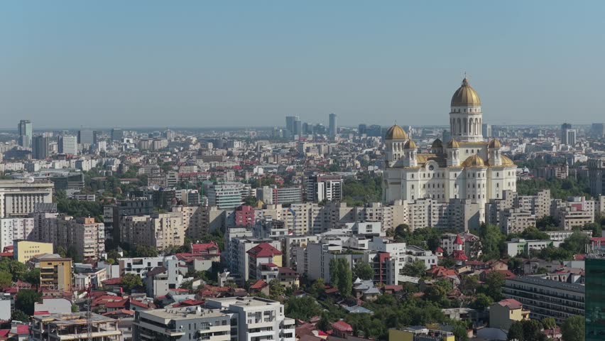 Bucharest, Romania, National Cathedral. Aerial 4K video with the biggest Orthodox cathedral in the world with Bucharest in background. People
