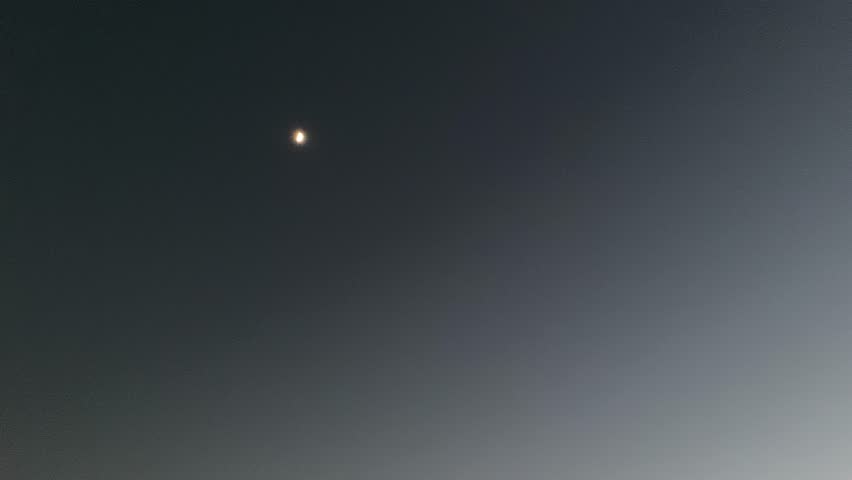 moon rising during golden hour, glowing sunset with colorful sky. Dramatic Evening.