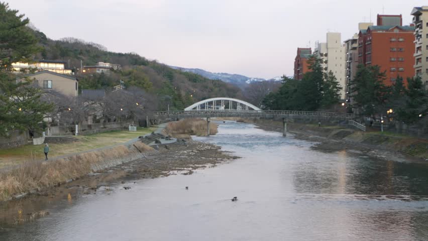 landscape view of river through city of Kanazawa with bridge cross over river in Kanazawa city in sunset sundawn time. view of Kanazawa city with river through town