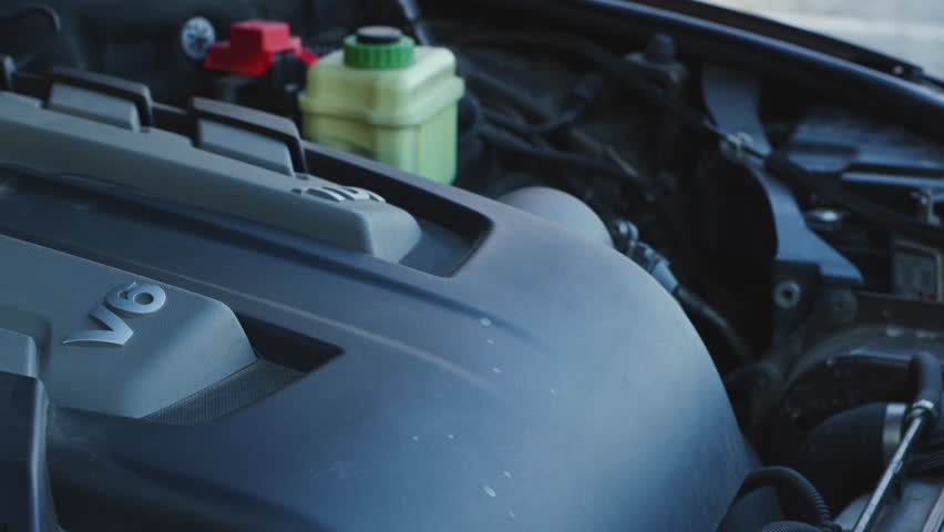 Diesel car v6 engine revving in open engine bay, close up cover movement with deep mechanical sound for foley and auto service scenes