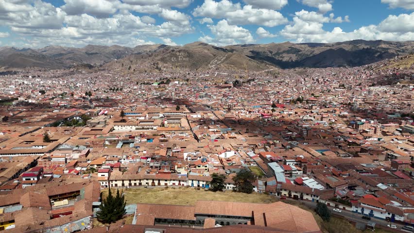 Wide aerial panorama of Cusco city in the Andean mountains, Peru, with clear sky