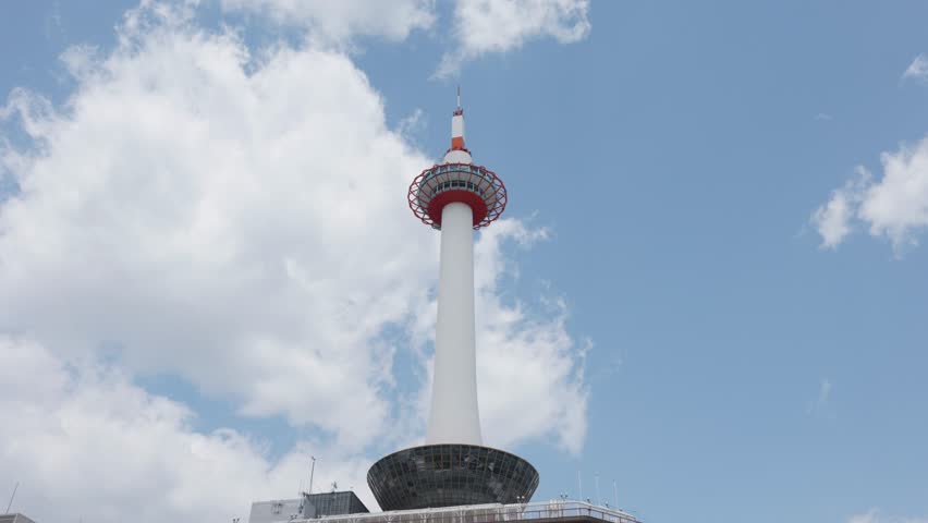 Kyoto Tower with blue sky and clouds on a sunny day in Kyoto, Japan.