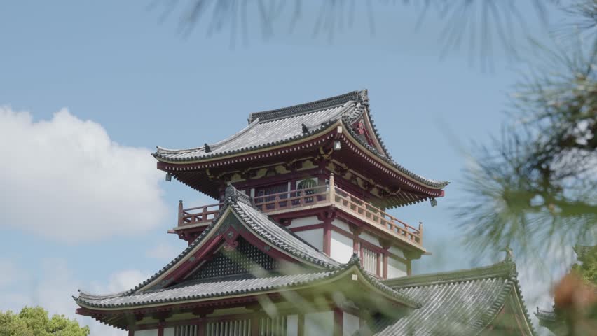 Traditional castle tower on a sunny day at Fushimi Castle, Kyoto, Japan.
