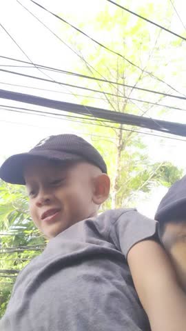 video portrait of a boy wearing a black hat talking about something