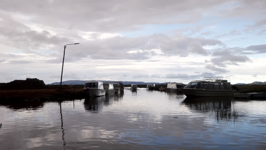 Speedboat Cruising on Lake Titicaca At Dusk In Uros Floating Islands In Peru. - handheld shot