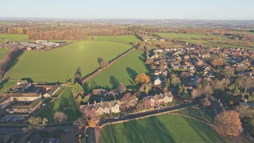 Drone shot of traditional stone village of Bretton nestled within rolling parkland and farmland of West Yorkshire, UK, immediate heritage context for the nearby Yorkshire Sculpture Park