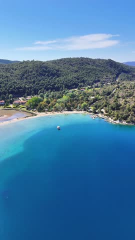 Aerial drone view of Fteroti Beach with sandbanks, shallow lagoon and turquoise water in Sithonia, Chalkidiki, Greece. Coastal Mediterranean landscape.