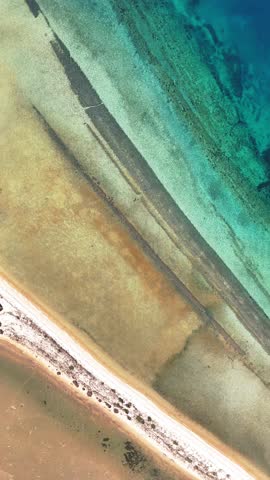 Aerial drone view of Fteroti Beach with sandbanks, shallow lagoon and turquoise water in Sithonia, Chalkidiki, Greece. Coastal Mediterranean landscape.