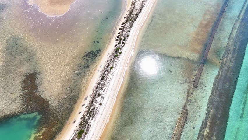 Aerial drone view of Fteroti Beach with sandbanks, shallow lagoon and turquoise water in Sithonia, Chalkidiki, Greece. Coastal Mediterranean landscape.