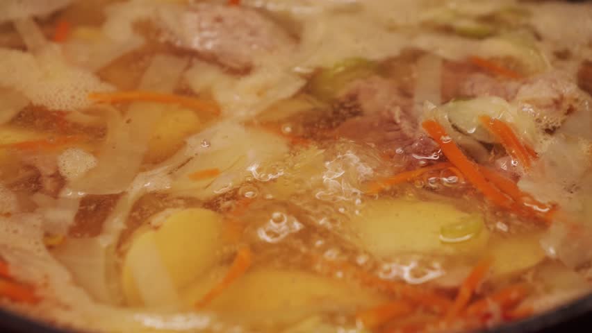 Homemade Shchi soup with chopped white cabbage cooked in bone broth, tasty soup close up. High quality 4k footage