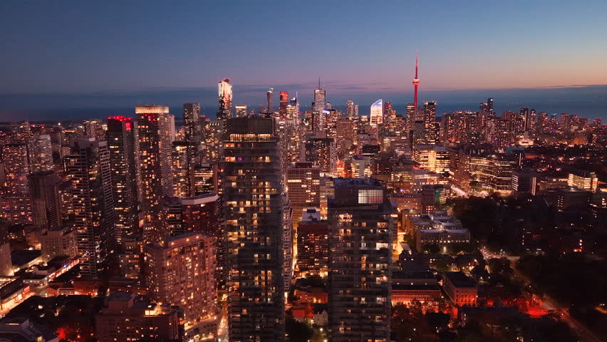 Drone view of Toronto's nighttime skyline. City lights at night. Downtown skyscrapers seen from above. Toronto, Ontario, Canada.