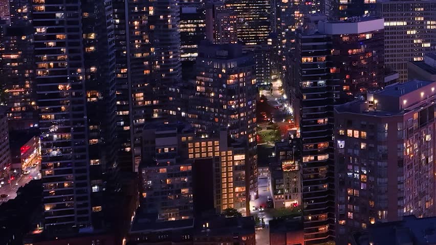 Drone view of the evening Toronto skyline. City lights. Downtown skyscrapers viewed from above. Toronto, Ontario, Canada.