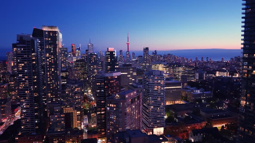 Drone view of the evening Toronto skyline. City lights. Downtown skyscrapers viewed from above. Toronto, Ontario, Canada.