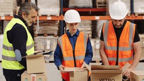 Team of warehouse workers, including a female employee, receiving training from their manager on how to properly pack and ship orders - Powered by Shutterstock - Get 15% off with code: PIKWIZARD15