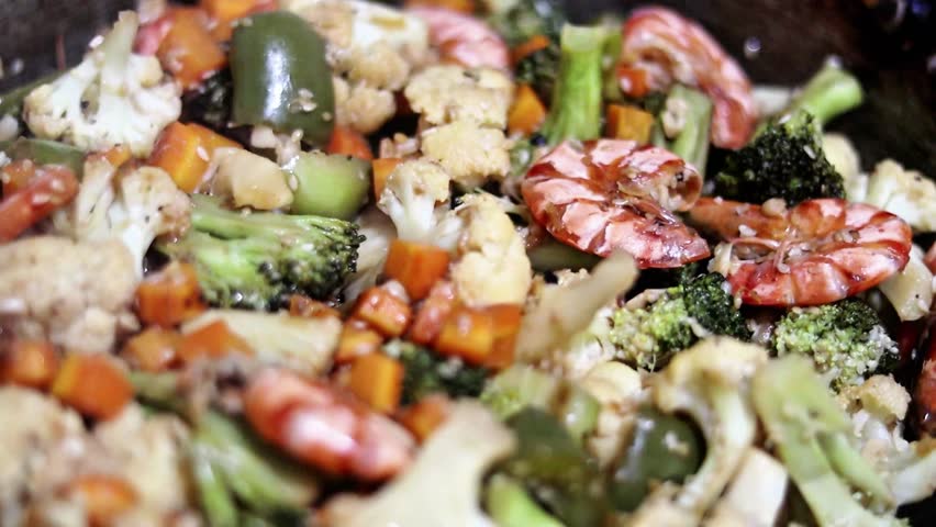 Stir-fried vegetables with shrimp on a plate on the dining table	.