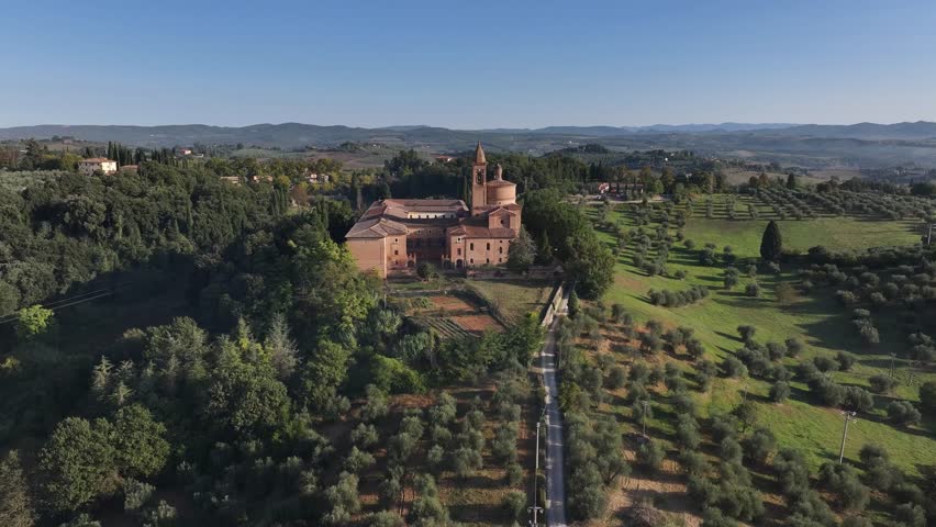 Extremely close-up aerial drone fly-over and tilt-down on the massive dome and bell tower of the Florence Cathedral, bathed in morning light.