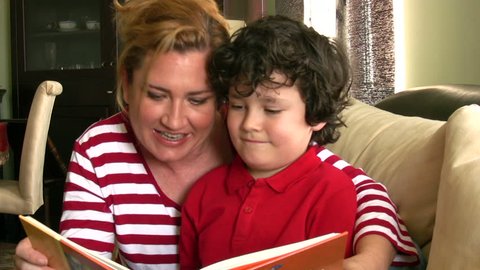 Mother and little boy reading a book  together
