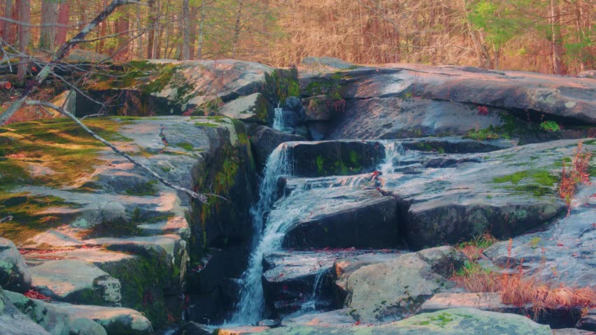 Scenic natural footage of Glendale Falls, one of the tallest and most powerful waterfalls in Massachusetts, USA, during the beautiful autumn season.