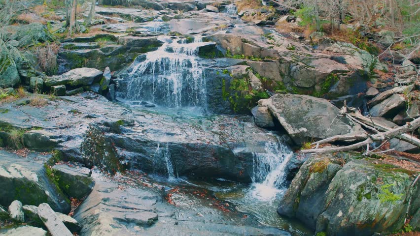 Footage of Glendale Falls, a beautiful and powerful natural waterfall in Middlefield, Massachusetts. The Glendale Brook cascades over 160 feet of rocky ledges and boulders surrounded by a lush forest