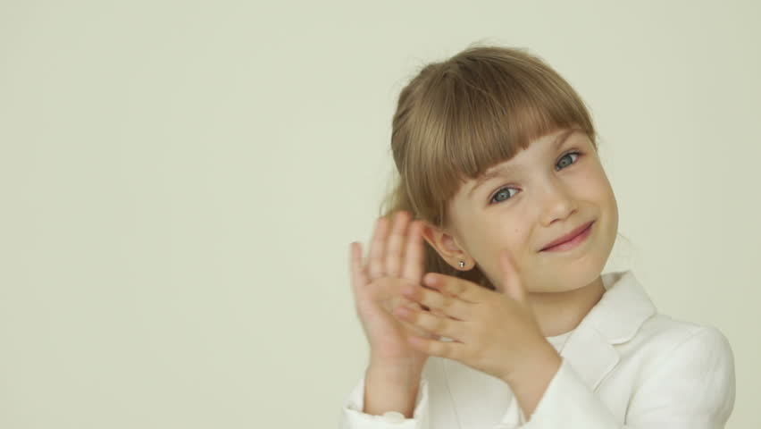 Little girl clapping her hands and nods
