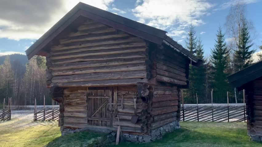 Traditional Wooden Log Cabins in Rural Countryside