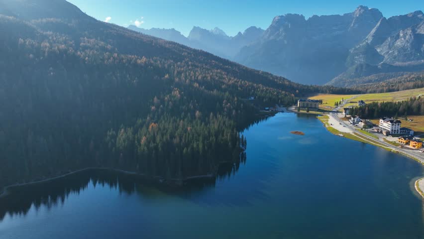 Aerial view of Misurina Lake, Lago di Misurina, in Dolomiti mountains in Italy, drone shot of foggy morning at Misurina lake, hiking in Itay