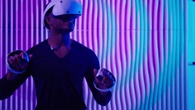 African American man in VR glasses using virtual reality in neon futuristic space typing in air with hands holding controllers male guy use futurism technology for gaming working exploring metaverse - Powered by Shutterstock - Get 15% off with code: PIKWIZARD15