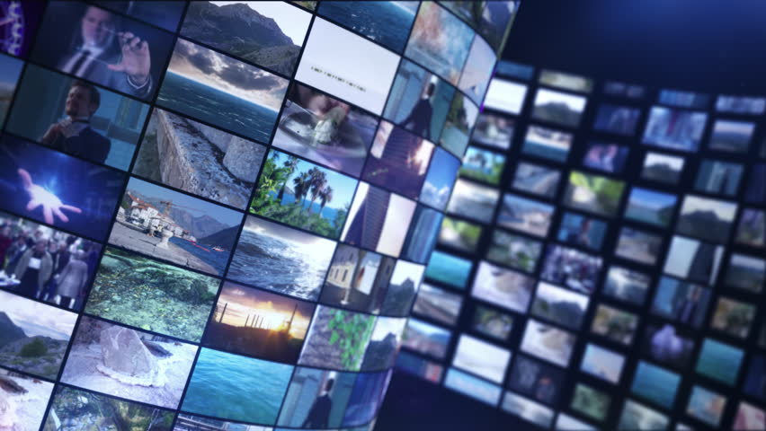 Curved video wall showing a collage of small moving images and broadcast screens