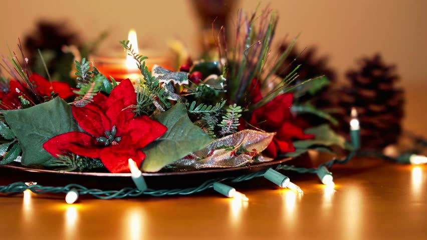 Ultra high-definition footage of a Christmas centerpiece decoration on a wooden table with smooth slide motion, ideal for holiday promotions, festive visuals, and seasonal décor concepts.