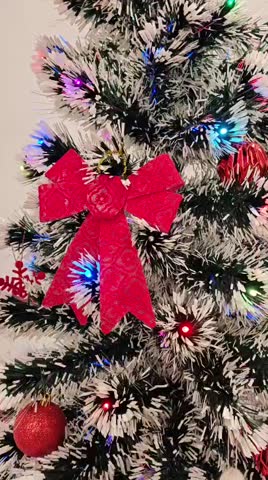 Close-Up of Decorated Christmas Tree with Red Ornaments and Colorful Lights