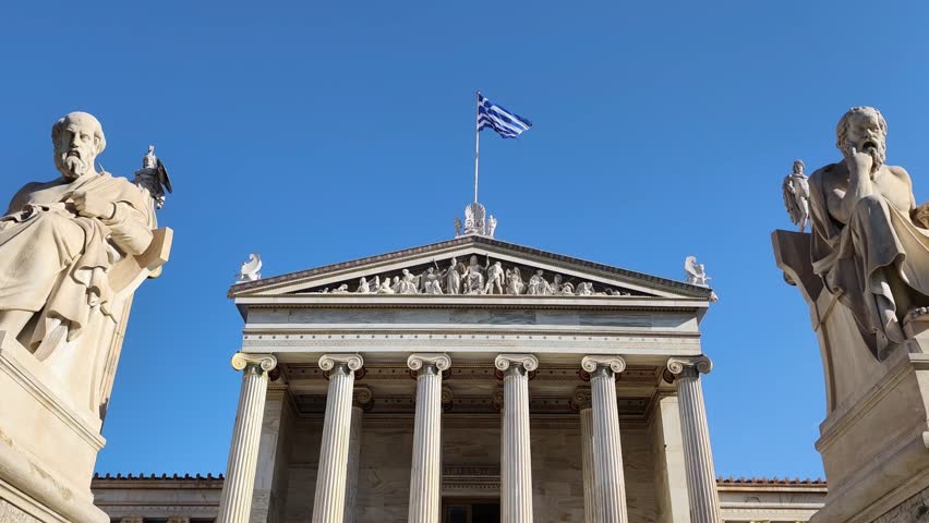 Exterior view of the Academy of Athens, the centerpiece of Theophil Hansen’s Neoclassical Trilogy, standing in downtown Athens, Greece, adorned with the statues of Plato and Socrates.