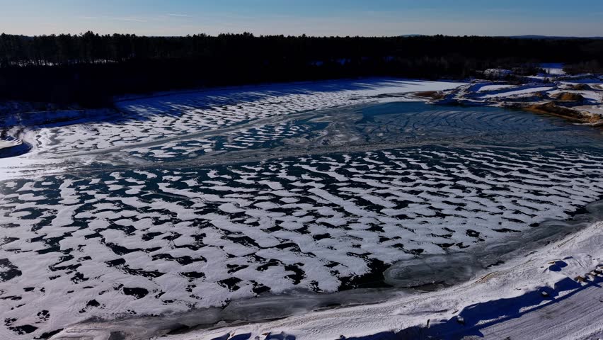 Winter time aerial view of an ice covered quarry in Dover, New Hampshire