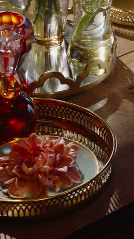 Charming Scene Featuring Oldfashioned Glass Bottle Adjacent To Blooming Blossoms On Richly Decorated Tray