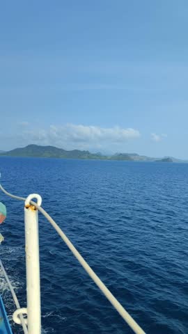 Large ferry with ropes on deck, close up view of small obak
