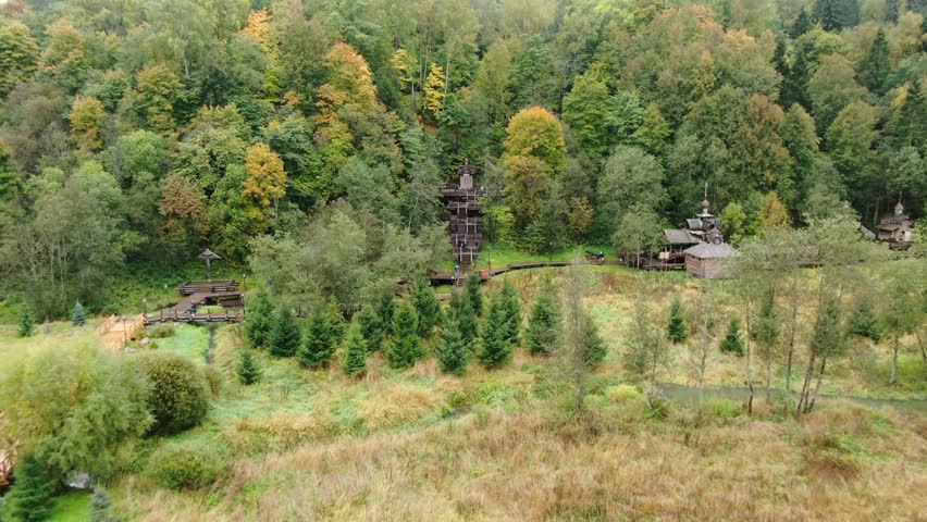 Forward drone flight toward forest wooden stairs